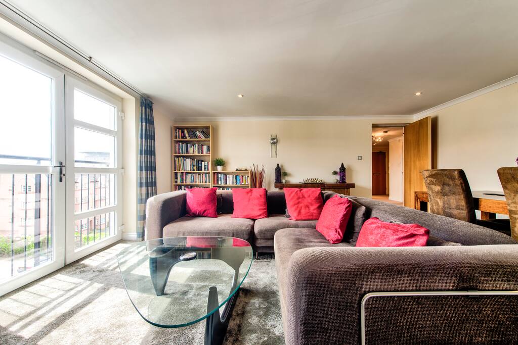 Luxury living area with large 5 seater sofa and dining table