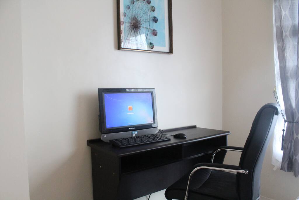 personal workspace with all-in-one desktop computer, executive chair, fast wifi