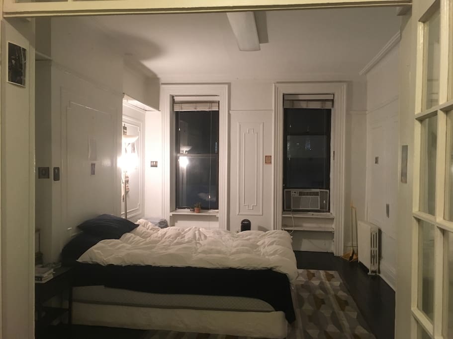 large bedroom with two windows, very bright