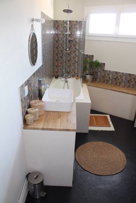 Salle de bain lumineuse avec baignoire et lavabo. Sèche cheveux à dispo, ainsi qu'une machine à laver !