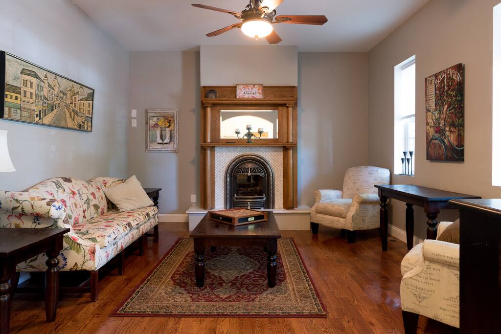Relax in front of the Victorian style fire place in the spacious, formal living room.