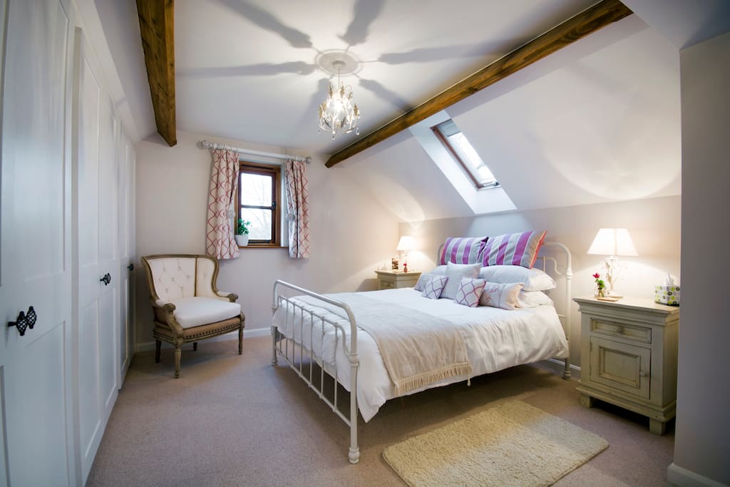 The pink family room, with sofa bed, king sized bed, and ensuite shower.