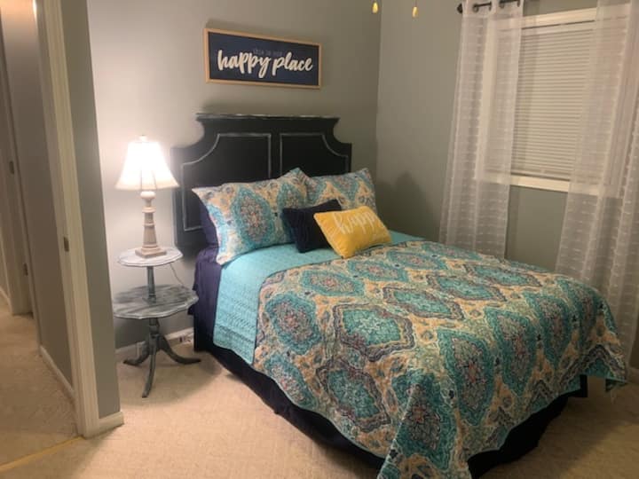Bedroom - Double - small nightstand with lamp, full closet, small table with drawers, and a mirror.