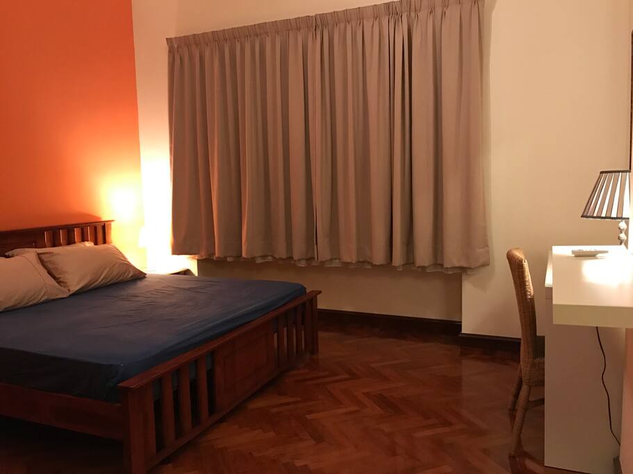 King-sized double bed in first bedroom, with built-in wardrobe, dressing table & ensuite-bathroom.