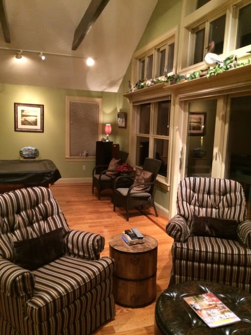 Nighttime view of billiard room an seating area