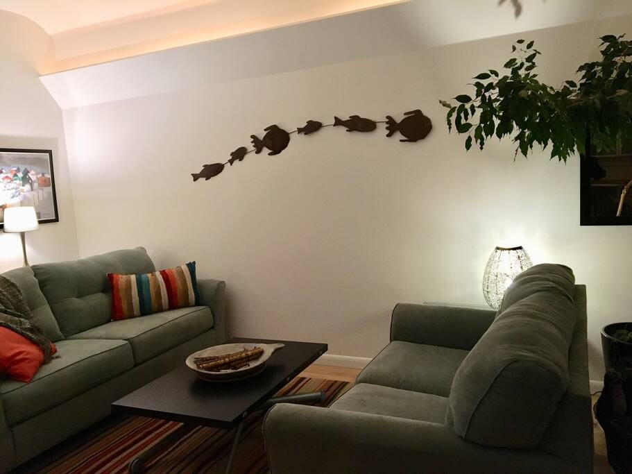 Living room: vaulted ceiling, 1 sofa, 1 loveseat