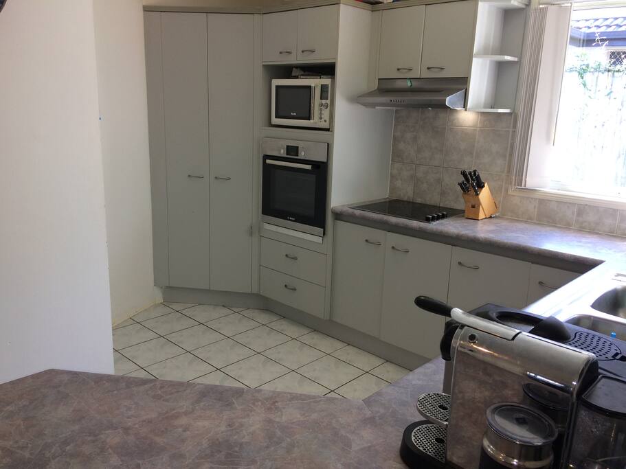 Kitchen with Bosch dishwasher oven and stovetop, Nespresso coffee machine