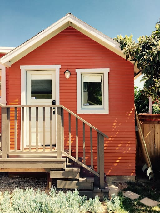 Tangerine-colored exterior of cottage with PRIVATE ENTRY. So cute!