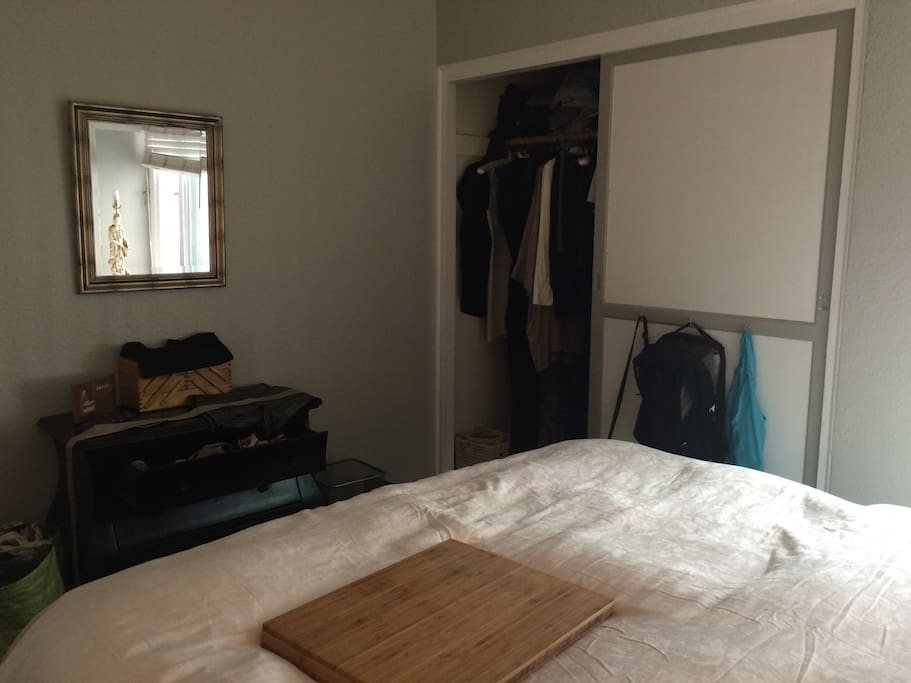 Two-tiered closet with hangers for clothing and luggage. Various hand-made "mini desks" for working in bed.