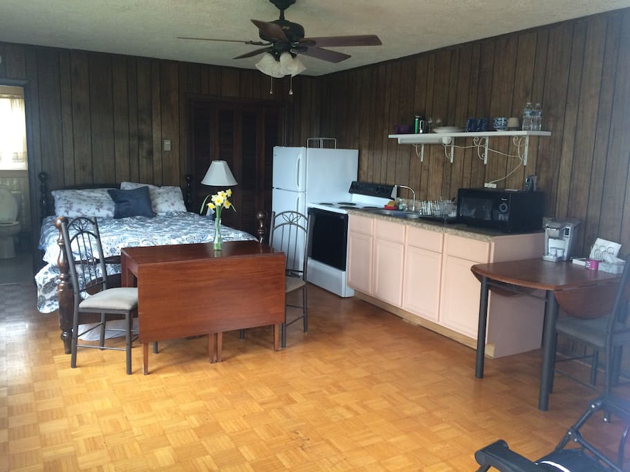 Inside the cottage is one double bed, table with chairs for two, kitchenette, bathroom, and walk-in closet.