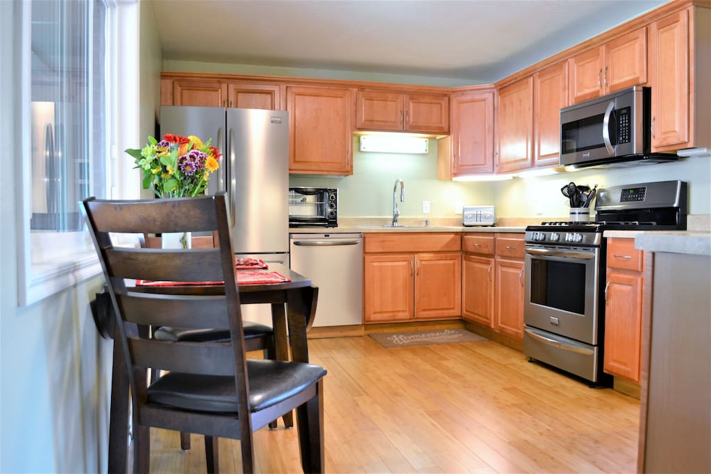 Eat in kitchen with a gas range, refrigerator with filtered water, microwave, toaster oven, and dishwasher. Fully stocked with pots/pans and utensils for cooking or eating in.
