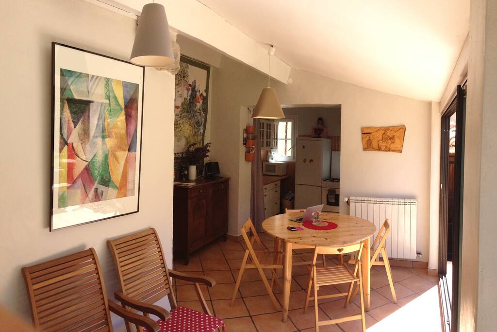 A view of the dining room and kitchen. The glass doors open full south the veranda. There is central heating, but most days you don't need it.