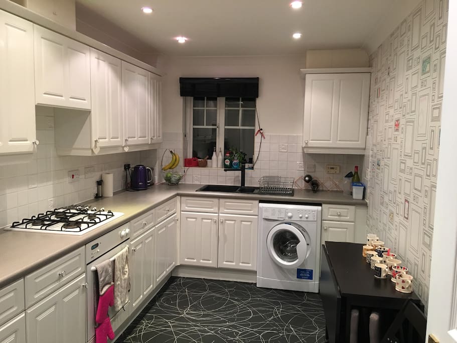 Separate kitchen with washer dryer and gas hob