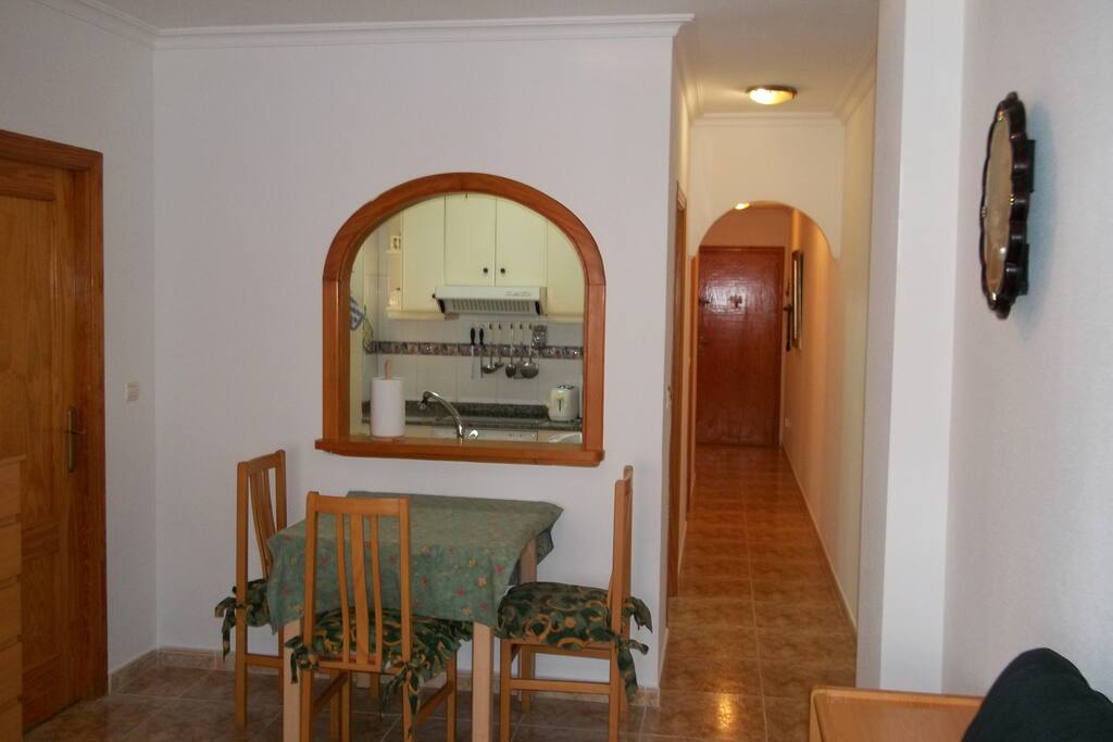 Kitchen table and view of hallway with bath room and master bedroom