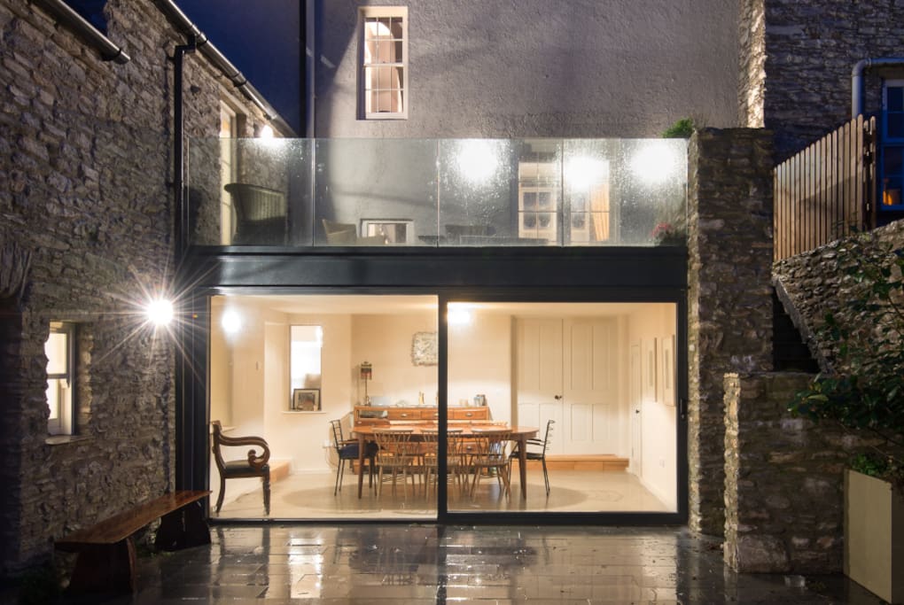 The back of the house shows that it has 4 levels. The basement level houses the cinema room which has a large double sofa bed so can be used as a 4th bedroom. A clever extension has provided a large dining space and terrace above. The yard is shared with the adjoining cottage.