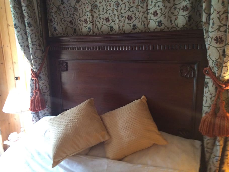 Four poster bed with tapestry