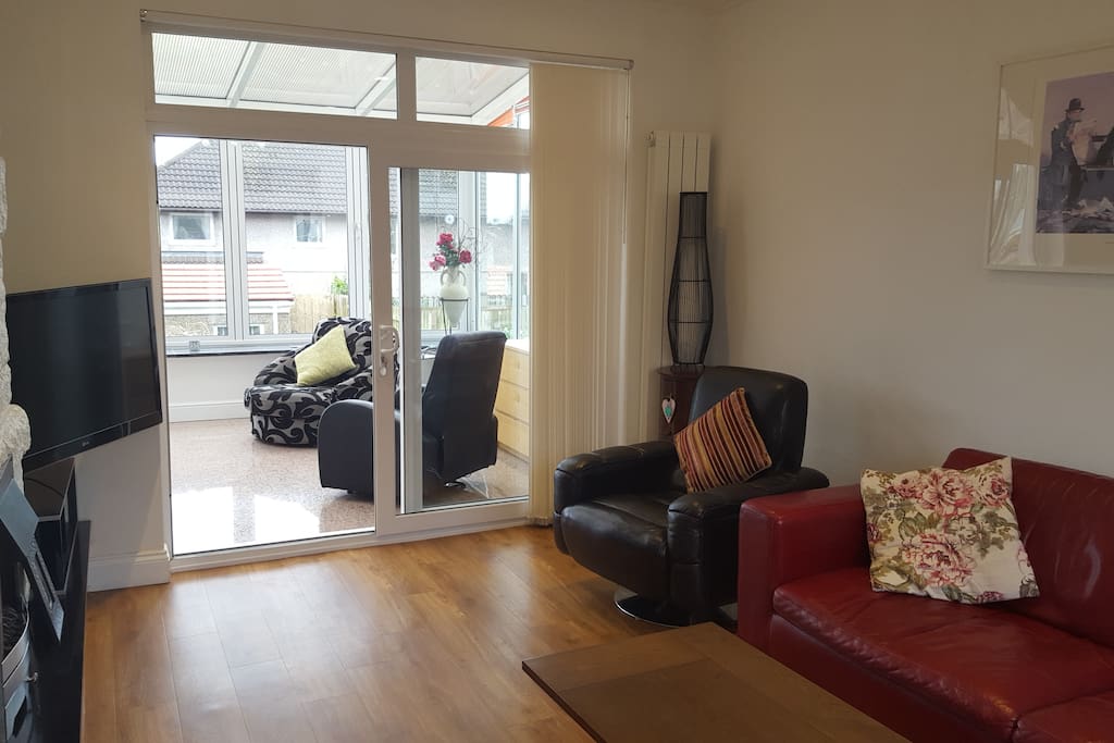 Lounge area with sliding doors through to sun lounge