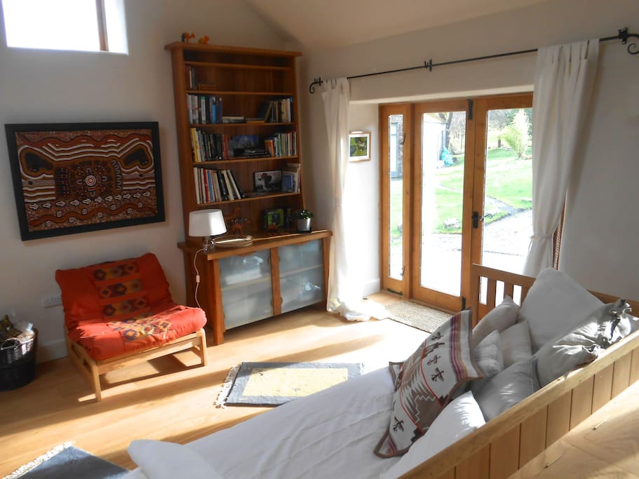 Lower Barn sunny studio area, with some of the feast of books & maps on Wales