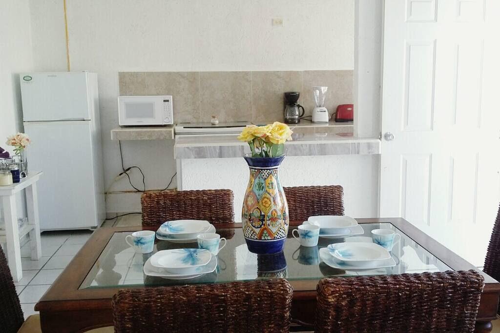 Dining room table looking into kitchen