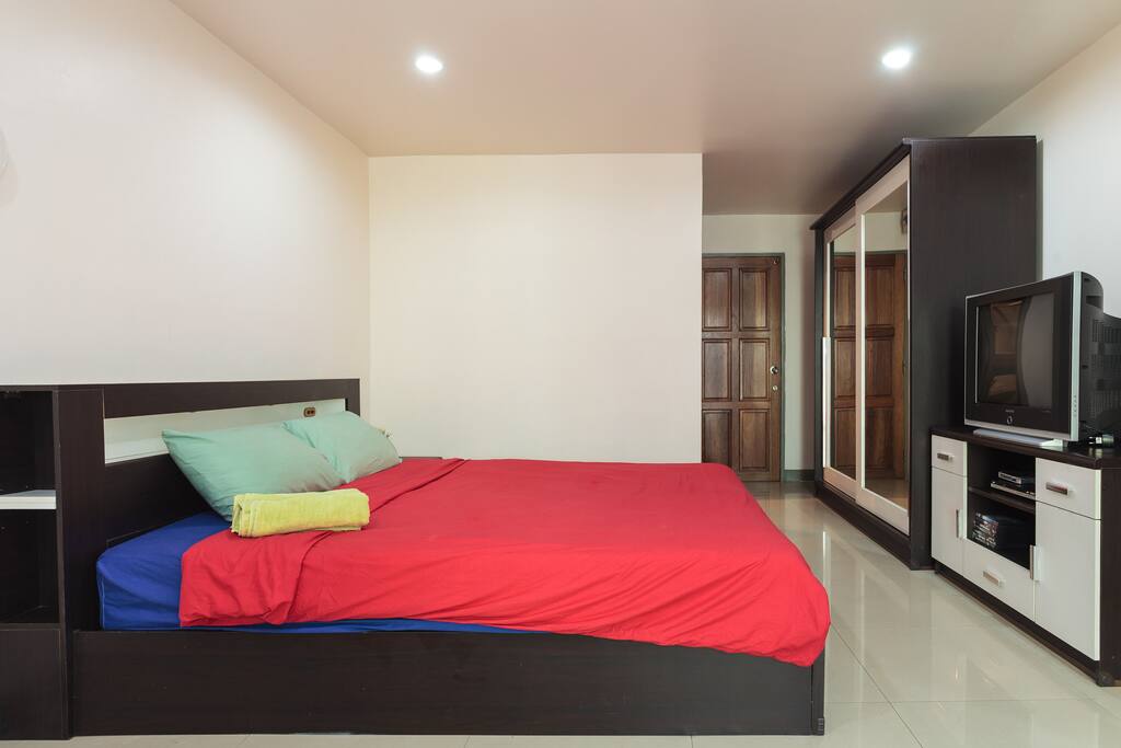 Comfy king size bed covered with soft mattress.