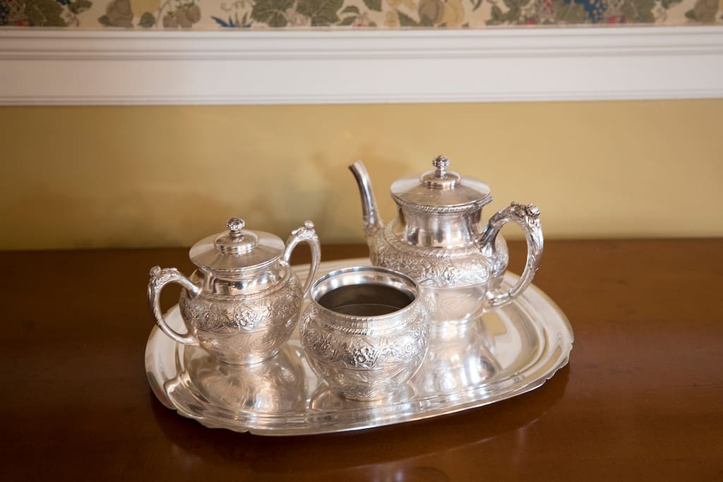 A silver tea set in the dining room.