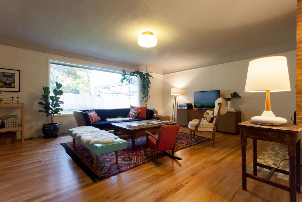 The main, open living room with view into the backyard.