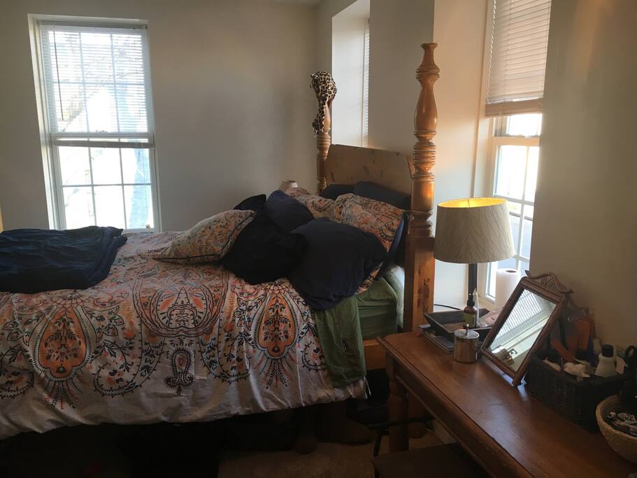 Bedroom 2 has large queen bed, tons of natural light, a TV with Roku, and an elliptical. Vanity comes equipped with several hair appliances (blow dryer, curling iron, hot curlers, etc.).