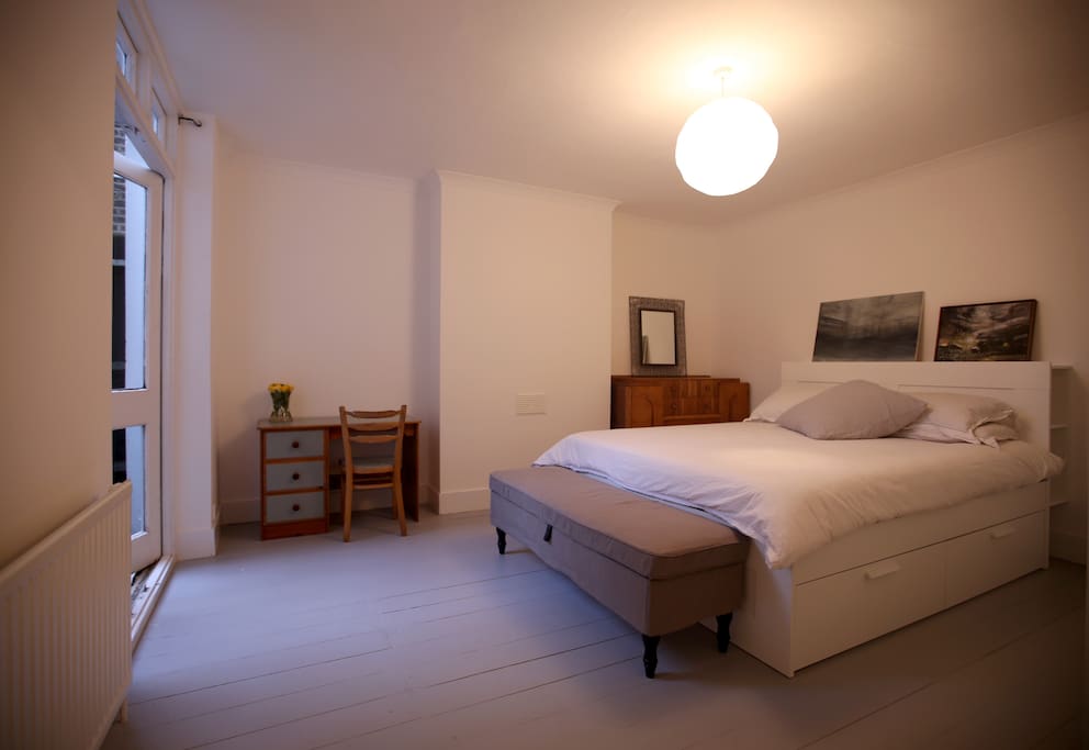 Double room, with desk and french doors onto small private courtyard.