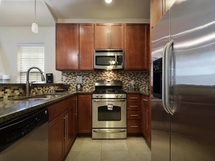 Updated kitchen with granite countertop and stainless steel appliances.