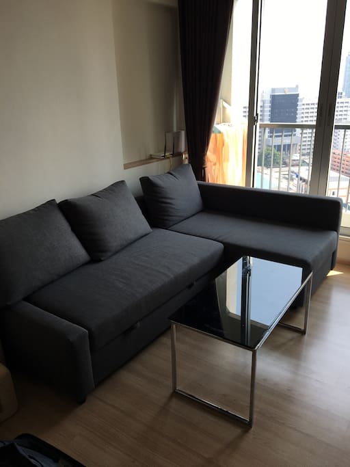 New comfortable sofa in living room which can be converted to bed for 2 people