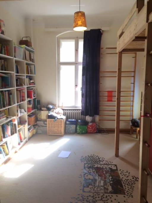 This is the kids' room. There are 2 loft beds (to the right, one above me). Loads of English and German books and games for all ages.