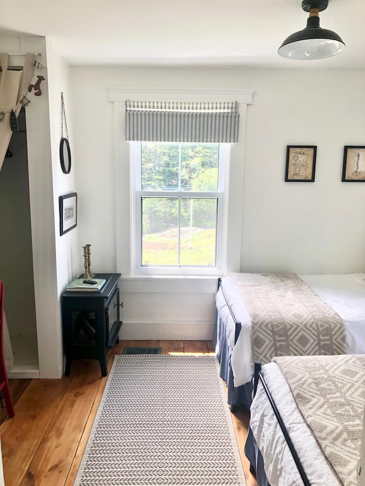 twin bedroom with forest view and fireplace