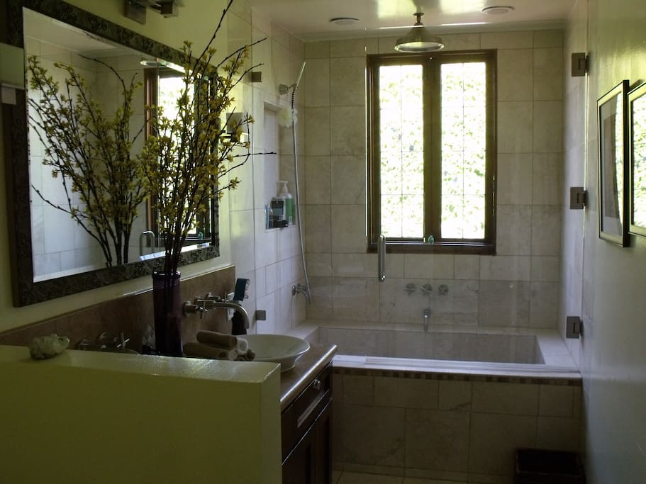 Bathroom number 1, between the two bedrooms with tub and rain shower.