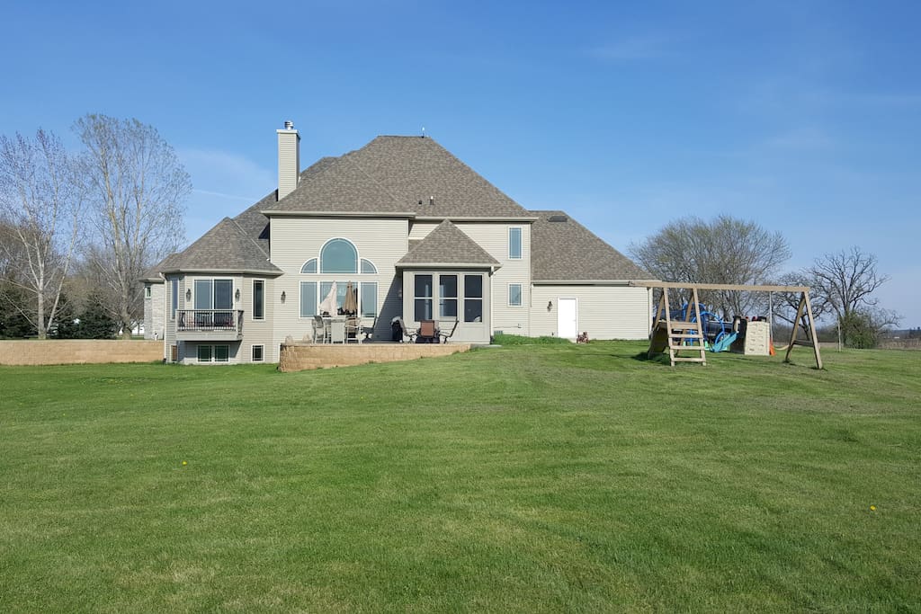 This is a view of the back of the house and including large patio and sun room.