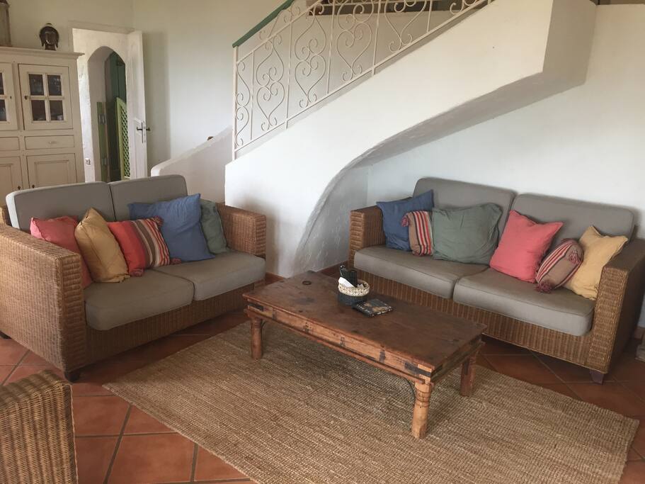 The lounge area with view of doorway into kitchen and stairs from the top floor