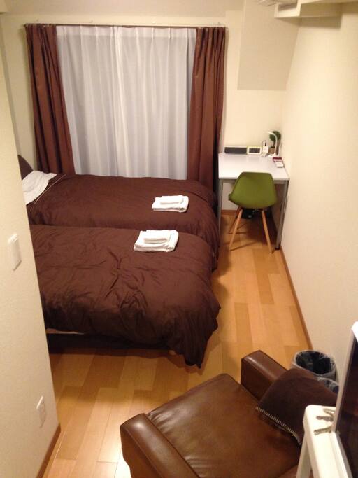 Two single beds, single sofa, table and chair