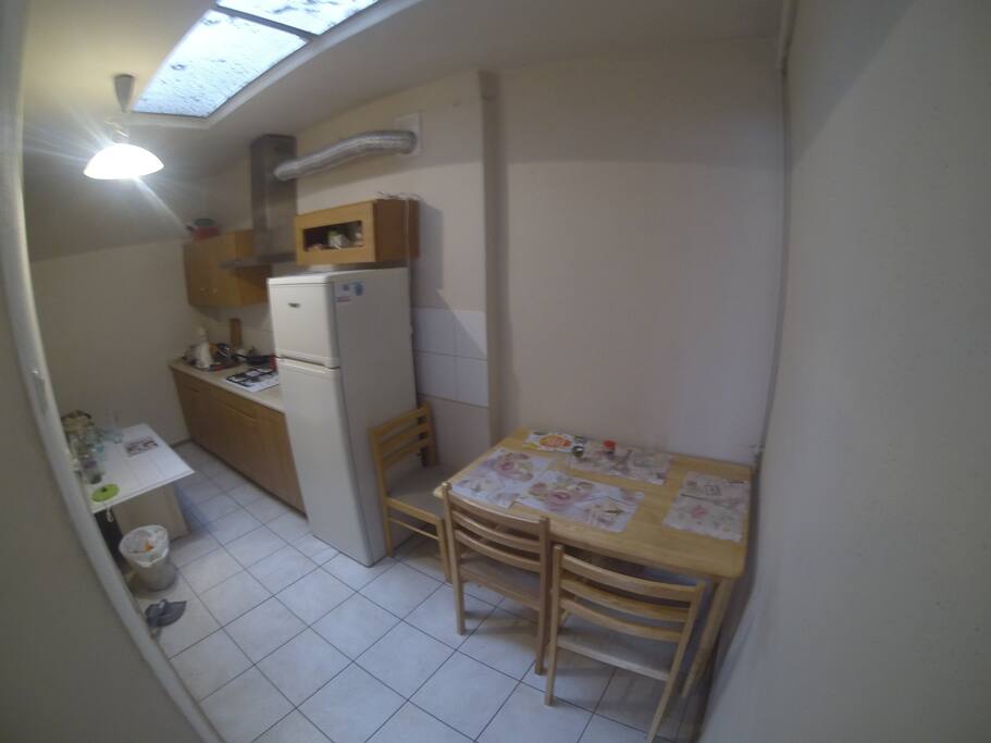 Kitchen has top window sunlight.