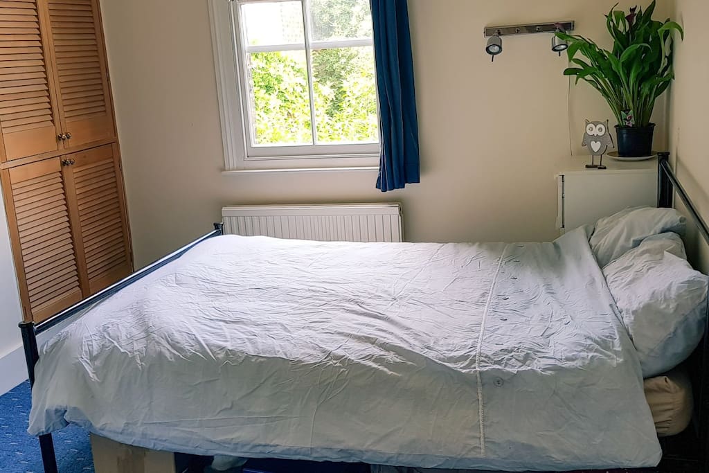 This is our guest bedroom - bright and airy with lots of storage for guests.