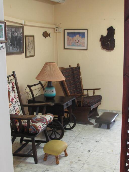 Country-style wooden armchair and rocking chair in a...