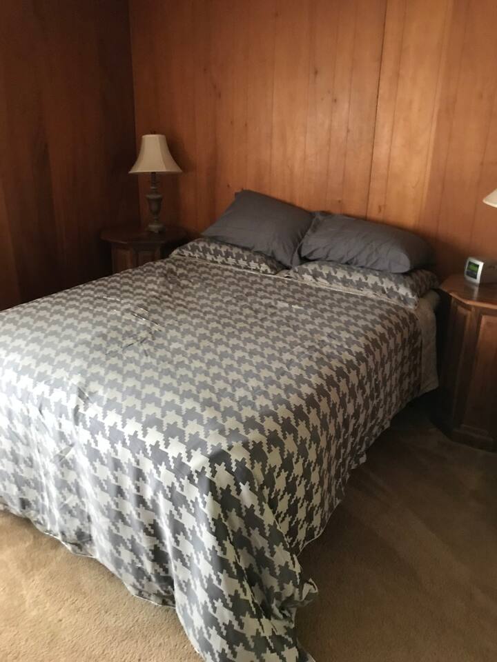 The Master bedroom. Who doesn't love wood paneling? 