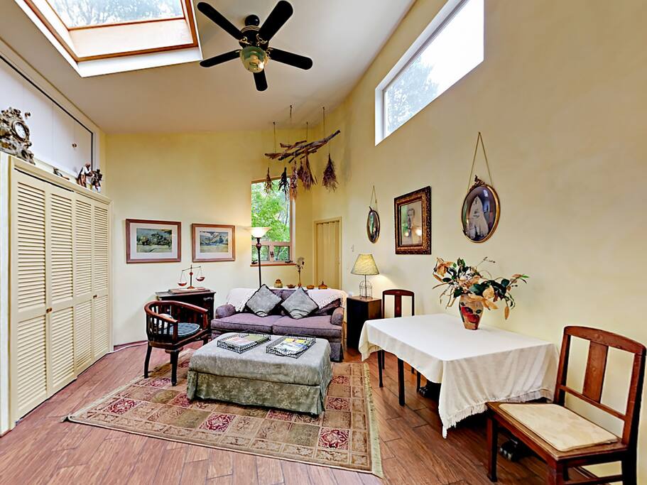 Charming living room with skylights and deck access.