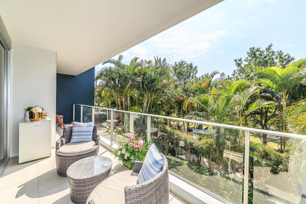 Sun filled balcony overlooking lush gardens