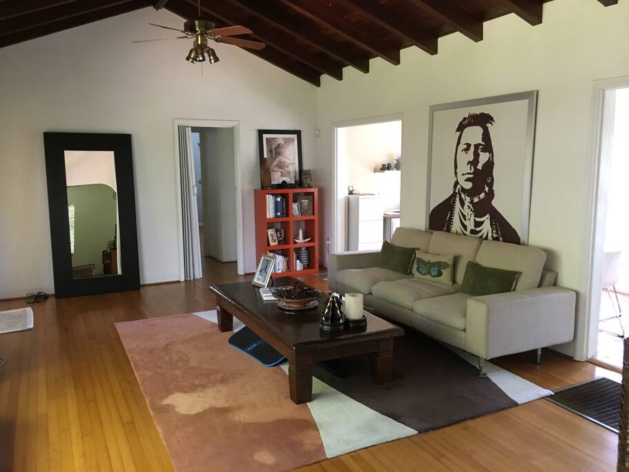 spacious living room w/ hardwood floors & mahogany vaulted ceiling