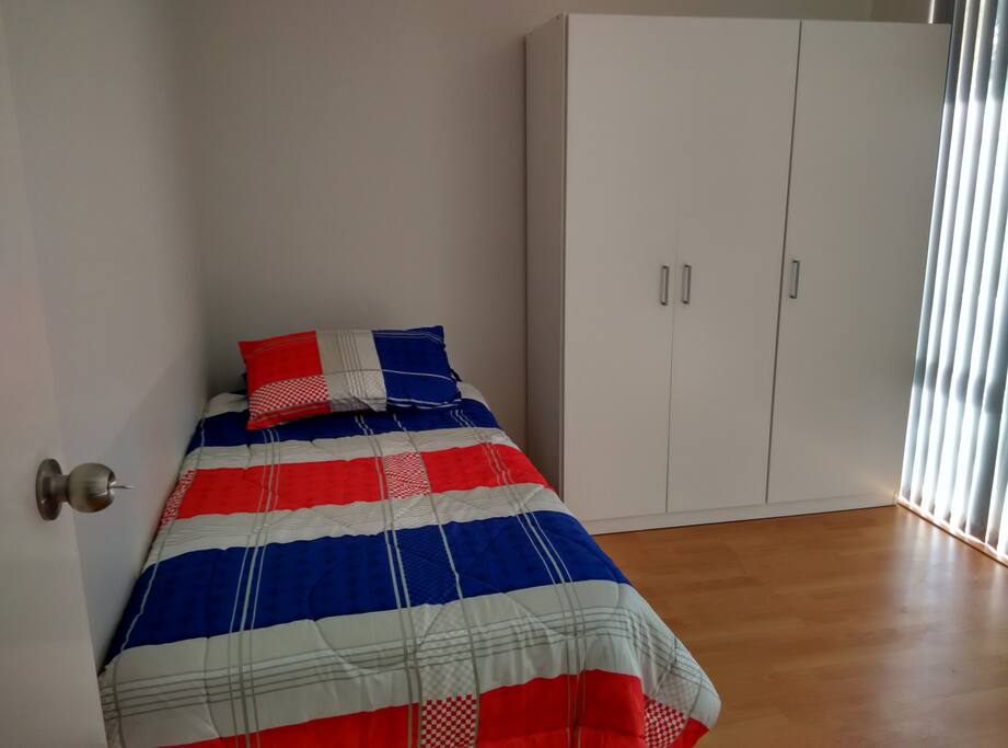 Clean comfortable bed. Window facing house front.