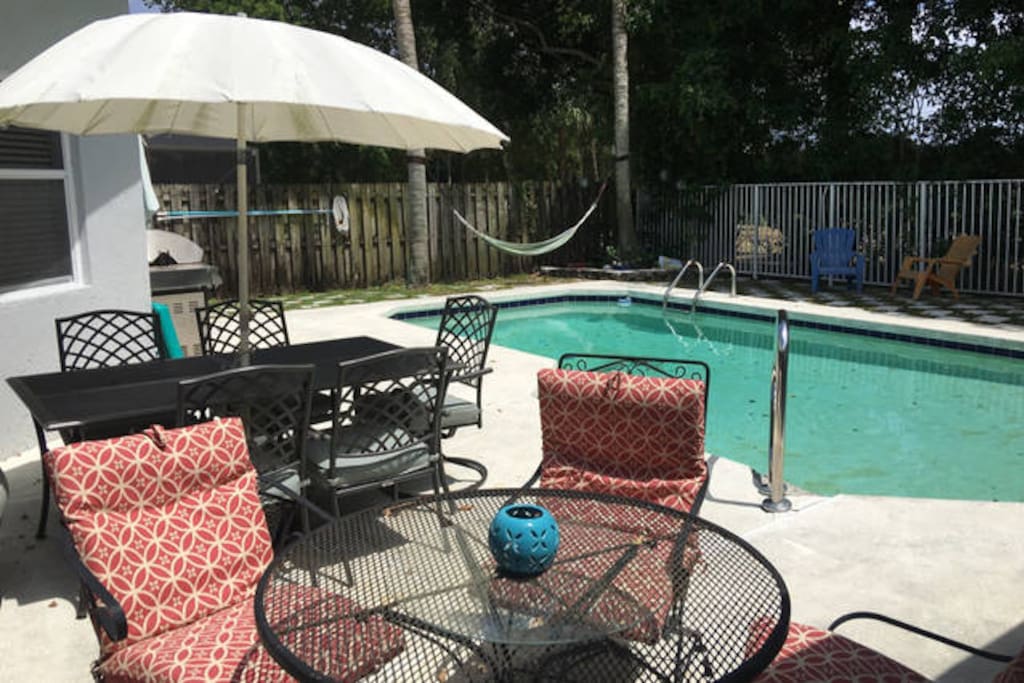 Pool with hammock in a shady area and a grill