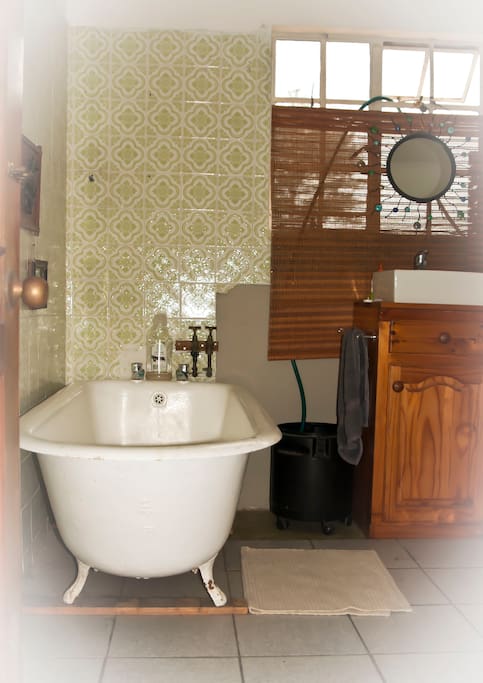 This is the Bathroom, with basin, wash machine & clothes horse.