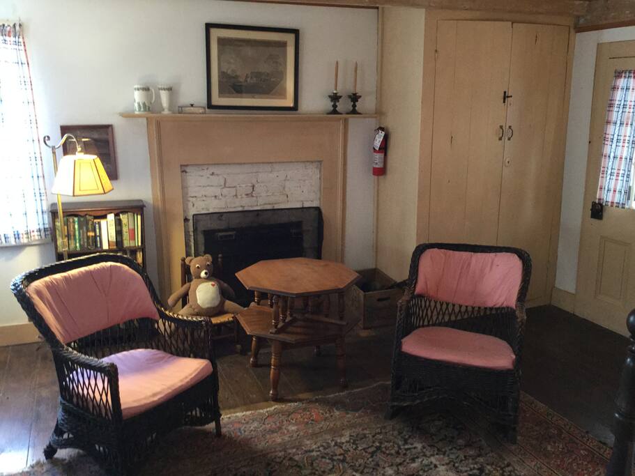 Black wicker chairs by fireplace