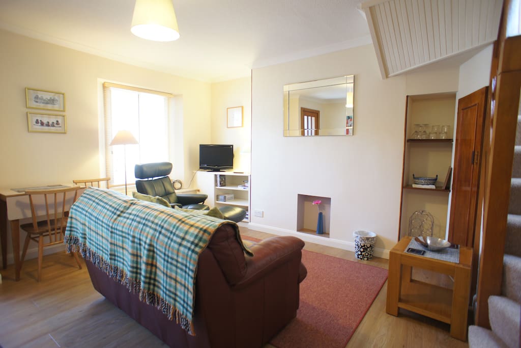 Bright living room with dining area and flat screen television and free WI-FI internet