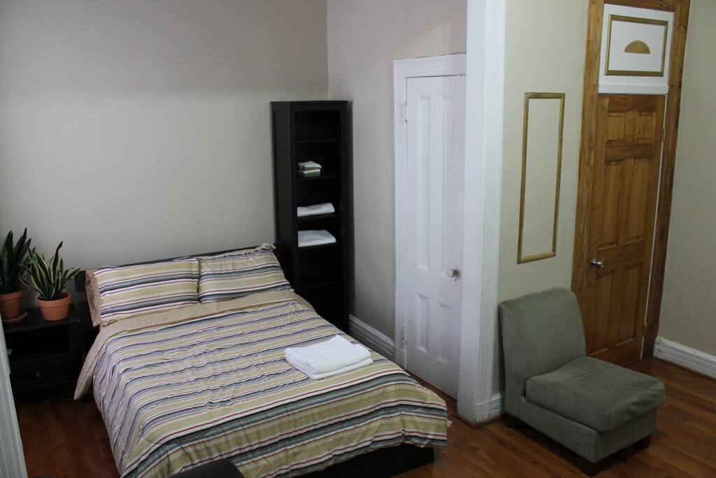 Spacious master bedroom with chair.