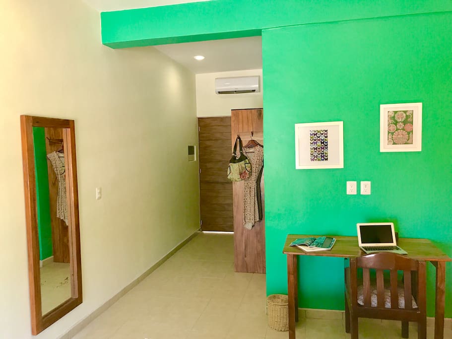 Desk, closet and mirror are among the modern amenities
